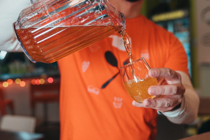 Man pouring beer into a glass from a pitcher